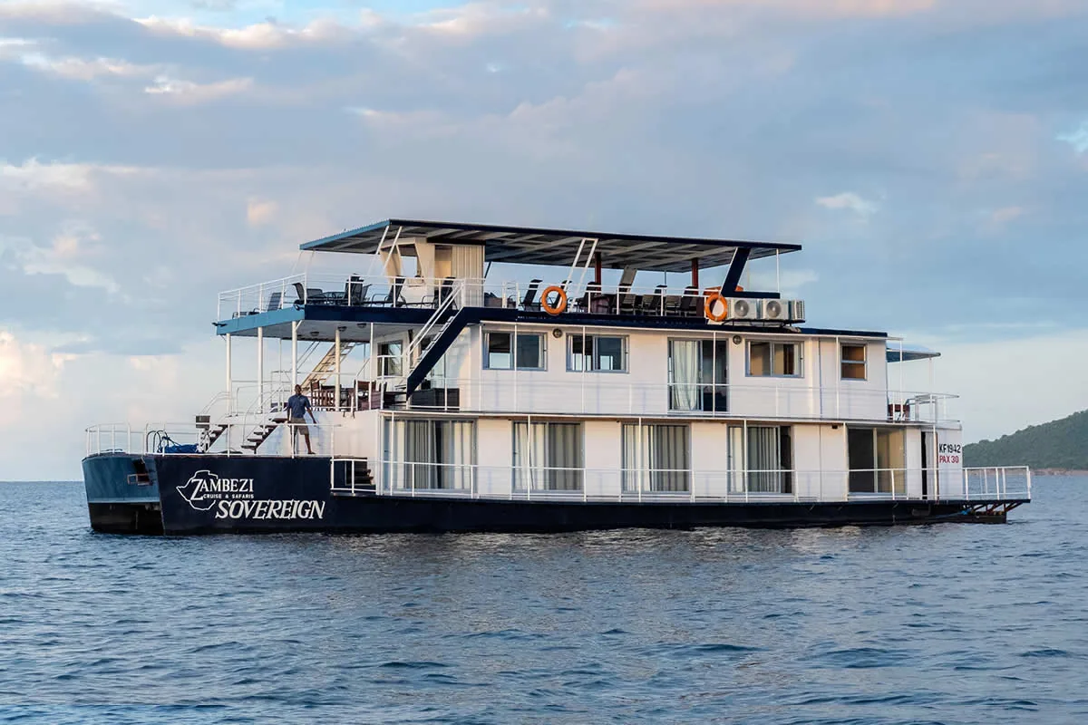 The Sovereign at anchor on Lake Kariba at dusk, crew member on the foredeck
